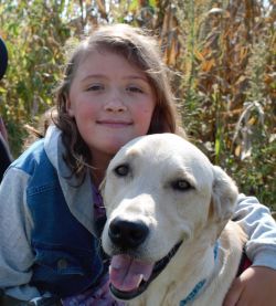 Kassidy is smiling at the camera. Tubbs is in front of her, looking like he is smiling at the camera too.