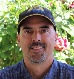 Clark is smiling at the camera. 